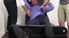 large Muscled Billy Laughs Hard while Tickled On belt Chair