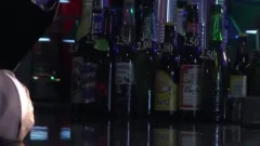 Two males In Suits Meet In A Bar