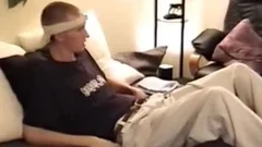 lad In A Visor Lays in nature's garb In sofa whilst Yanking His Boner